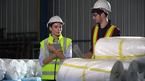 Group of worker man holding blueprint and woman using tablet checking list .. Stock Footage 246122449
