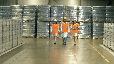 Group of worker moving through warehouse Stock Footage 77743206