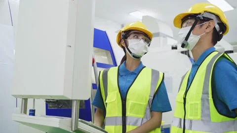 Group of worker wearing face mask in factory due to COVID-19 pandemic. Stock Footage 147910958