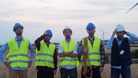 Group of workers and engineers putting on a protective helmet Stock Footage 218978274