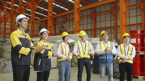 Group of workers applaud after factory manager is successfully trained. Stock Footage 237974420