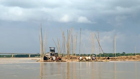 Group of workers building structural elements of the future bamboo bridge.   Stock Footage 112733211