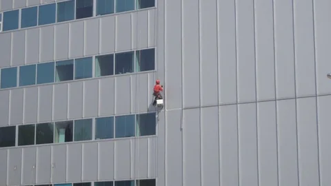 Group of workers cleaning windows service on high rise building Stock Footage 76203145