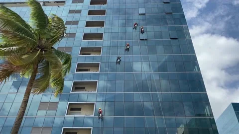 Group of workers cleaning windows service on high rise building Stock Footage 159978601