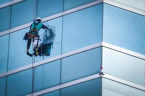 Group of workers cleaning windows service on high rise building Stock Photos