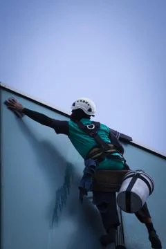 Group of workers cleaning windows service on high rise building Stock Photos