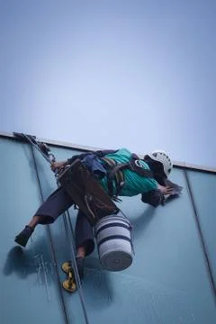 Group of workers cleaning windows service on high rise building Stock Photos