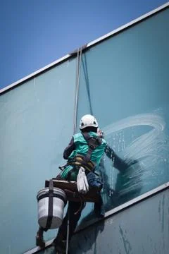 Group of workers cleaning windows service on high rise building Stock Photos