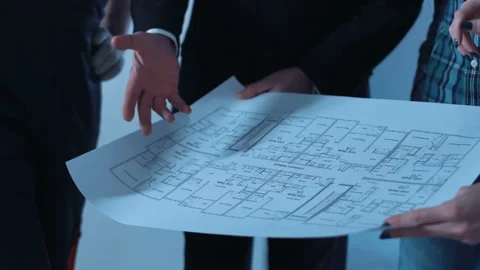 The group of workers discussing blueprints Stock Footage 100558251