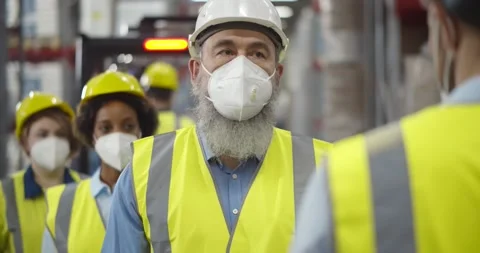 Group of workers with face mask in warehouse having temperature measurement Stock Footage 151395736
