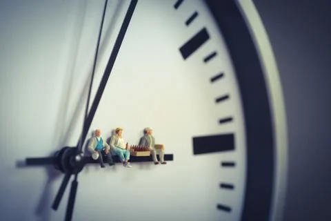Group of workers having break with beer while sitting on clock hand Stock Photos