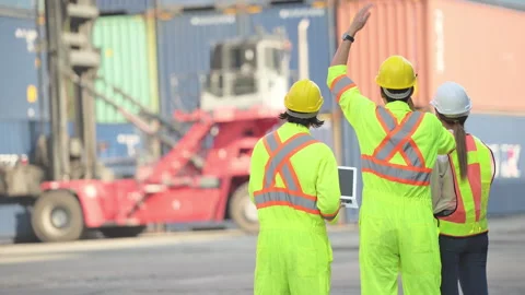 Group of workers in the import and export industry use walkie talkies Stock Footage 264473391