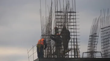 Group of workers jointing rebar rods for ferrocement framework of a new building Stock Footage 86156094