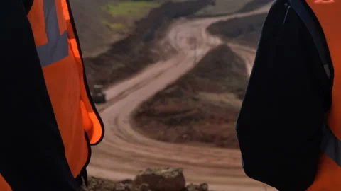 Group of workers in overalls actively speaking on board a bauxite quarry. Stock Footage 88795939