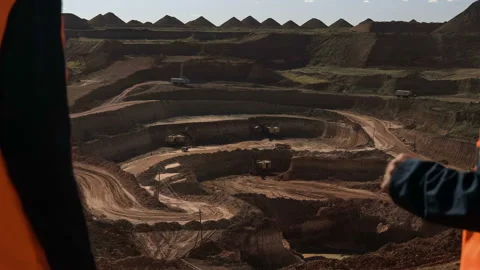 Group of workers in overalls actively speaking on board a bauxite quarry. Video stock 88795987