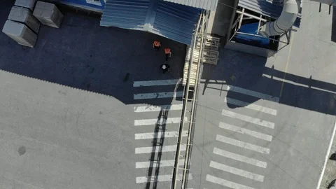 A group of workers passes through the plant Stock Footage 97185368