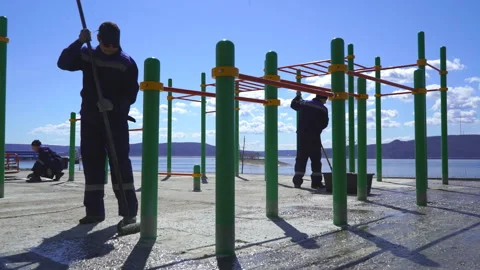 A group of workers prepares the Playground to cover with rubber crumb Stock Footage 91728390