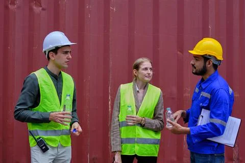 Group of workers resting from works by drinking water, cargo shipping busines Stock Photos