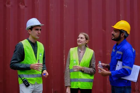 Group of workers resting from works by drinking water, cargo shipping busines Stock Photos