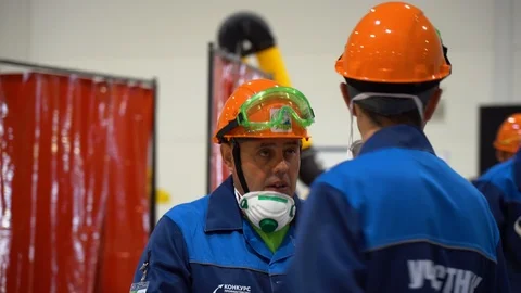 Group of workers in special blue uniform listen superiors instructions about job Stock Footage 126355564