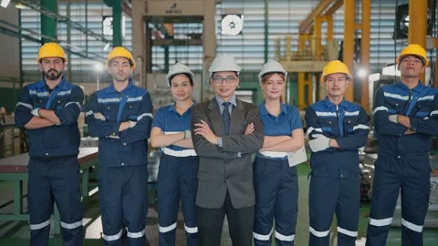 Group workers stand confidently in a factory Stock Footage 341925051