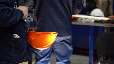 Group of workers stands near table with tools on background of production site Stock Footage 126355343