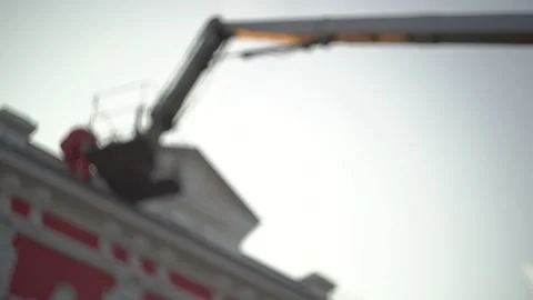 Group of workers at sunset repair, restore, decorate building in the city center Stock Footage 141790565