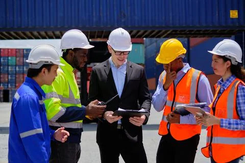 Group of workers teamwork at logistics terminal, cargo transportation industr Stock Photos