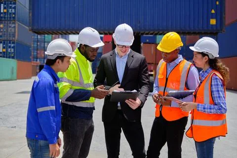 Group of workers teamwork at logistics terminal, cargo transportation industr Stock Photos