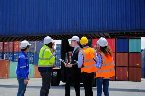 Group of workers teamwork at logistics terminal, cargo transportation industr Stock Photos