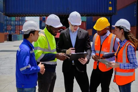 Group of workers teamwork at logistics terminal, cargo transportation industr Stock Photos