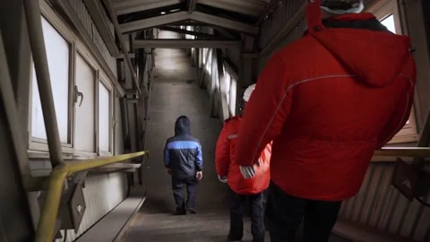 A group of workers walk down the corridor in the factory room. Stock Footage 178487088