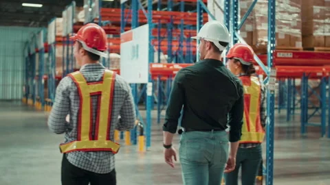 Group of  workers wearing helmet checking inventory and discussing in modern  動画素材 204917814