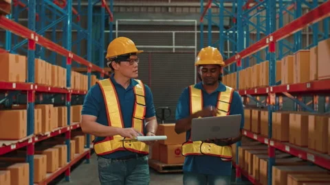 Group of  workers wearing helmet checking inventory and discussing in modern  스톡 동영상 204918211