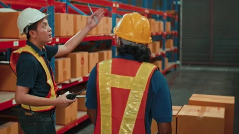 Group of  workers wearing helmet checking inventory and discussing in modern  Vídeo Stock 204918503