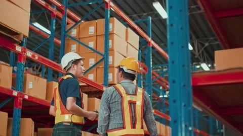 Group of  workers wearing helmet checking inventory and discussing in modern  Video stock 204918568