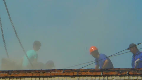 A group of workers working on the roof of a multi-storey building Stock-Footage 112684039