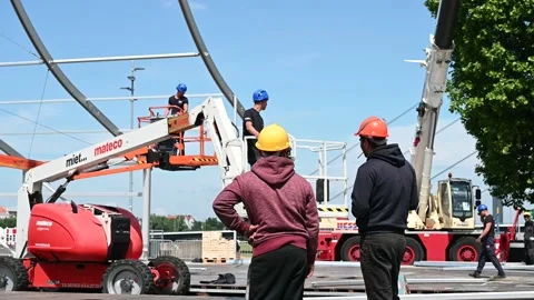 Group of workers with yellow helmets on construction site. Stock Footage 223611494