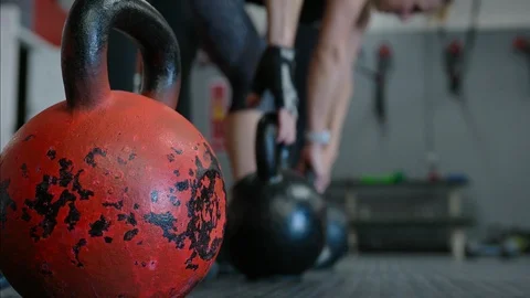 Group workout closeup with trainer executing kettlebell lifts in fitness Stock Footage 95942267