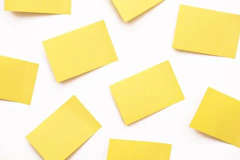 A group of yellow post-it notes memo sticker papers note pads on the wall Stock Photos