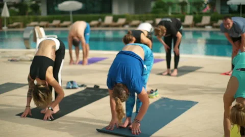 Group yoga class near the pool slow motion Stock Footage 63480393