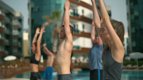 Group yoga class near the pool slow motion Video stock 63480975