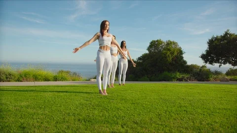 Group yoga session at park with view on an ocean Stock Footage 129998043