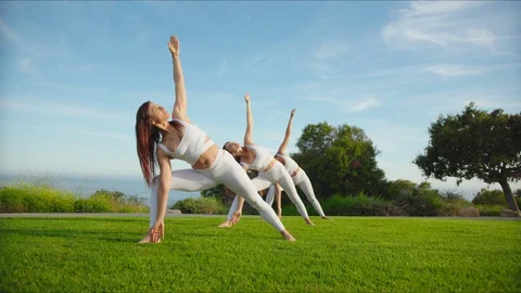 Group yoga session at park with view on an ocean Stock Footage 129998429