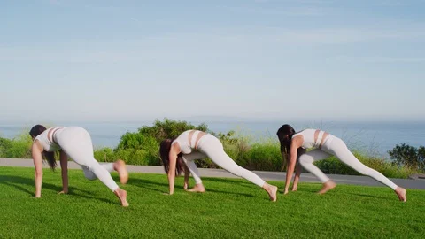 Group yoga session at park with view on an ocean Stock Footage 130043926