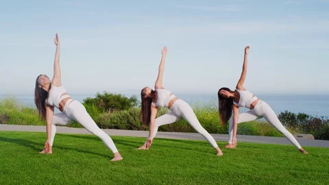 Group yoga session at park with view on an ocean Stock Footage 130043954