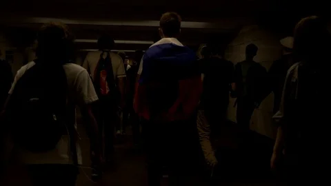 A group of young activists with the Russian flag is walking along an underpass. Stock Footage 117537083