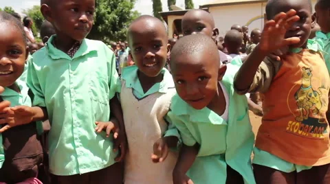 Group of young African children wave at camera smiling and happy Stock Footage 57948197