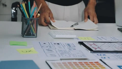Group of young application developers analyzing uxui mobile app templates d.. Stock Footage 316828031