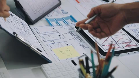 Group of young application developers analyzing uxui mobile app templates d.. Stock Footage 316828040